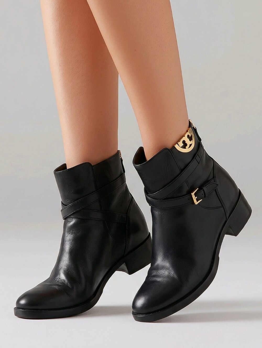 Tory Burch - Elegant black leather ankle boots with gold-tone hardware. Size 8